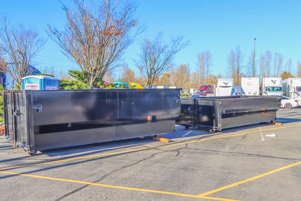 Professional dumpster rental service with roll-off container on residential driveway in Delavan